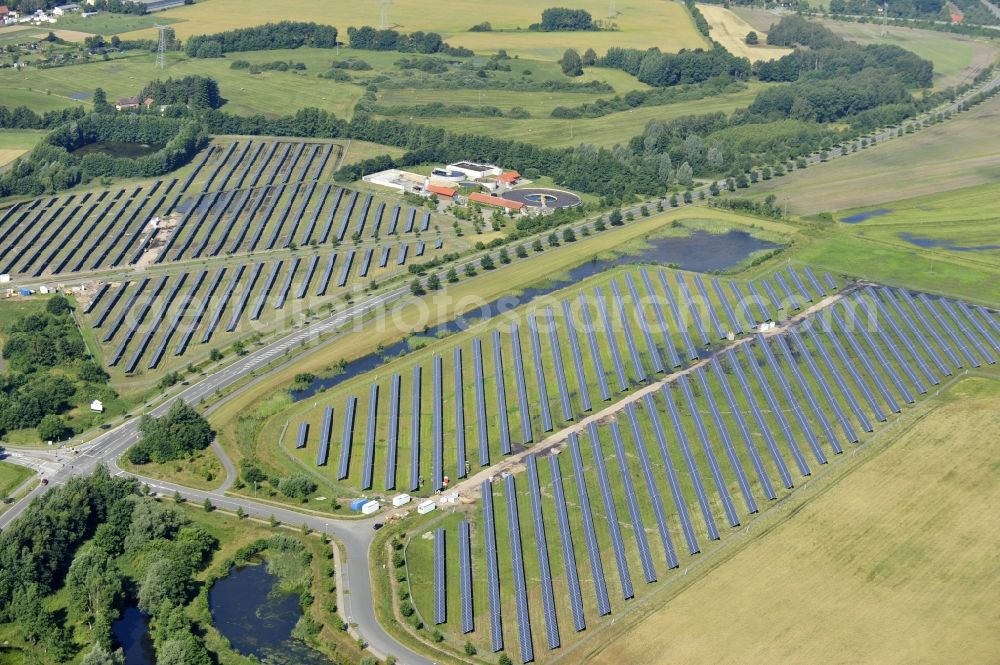 Boizenburg from above - Boizenburg 08/07/2012 Newly built solar panel, photovoltaic solar park or along the road 5 on the industrial and commercial area of the eastern edge of Boizenburg / Elbe. The plant operator is the EEPro Company