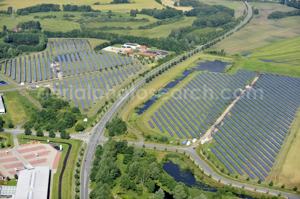 Boizenburg from the bird's eye view: Boizenburg 08/07/2012 Newly built solar panel, photovoltaic solar park or along the road 5 on the industrial and commercial area of the eastern edge of Boizenburg / Elbe. The plant operator is the EEPro Company