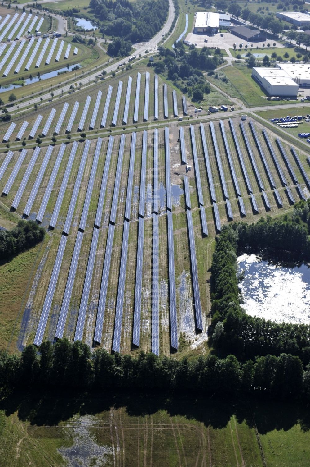 Boizenburg from above - Boizenburg 08/07/2012 Newly built solar panel, photovoltaic solar park or along the road 5 on the industrial and commercial area of the eastern edge of Boizenburg / Elbe. The plant operator is the EEPro Company