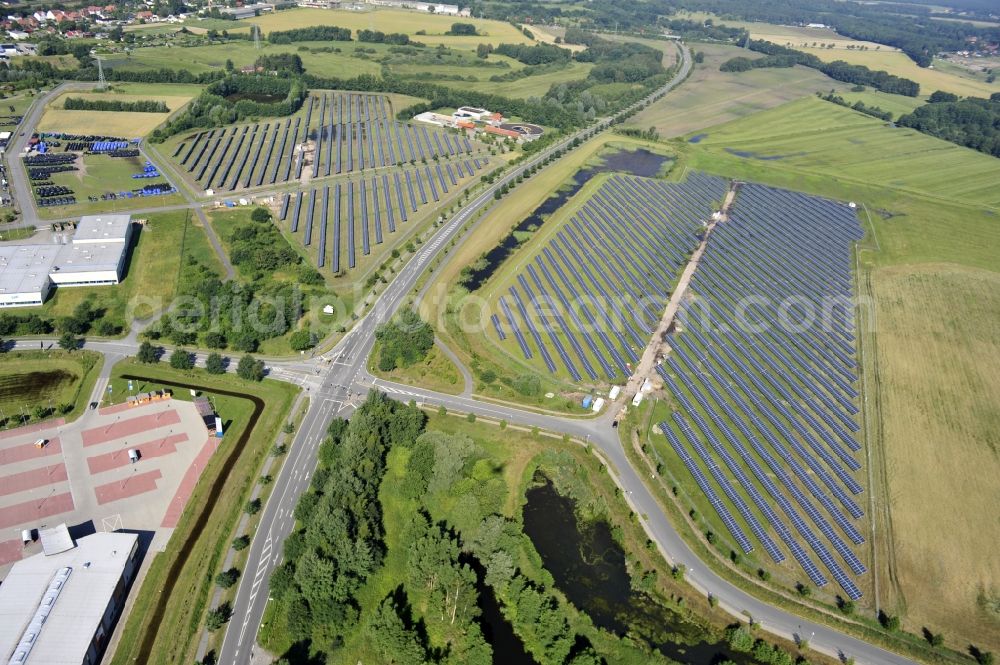 Boizenburg from the bird's eye view: Boizenburg 08/07/2012 Newly built solar panel, photovoltaic solar park or along the road 5 on the industrial and commercial area of the eastern edge of Boizenburg / Elbe. The plant operator is the EEPro Company