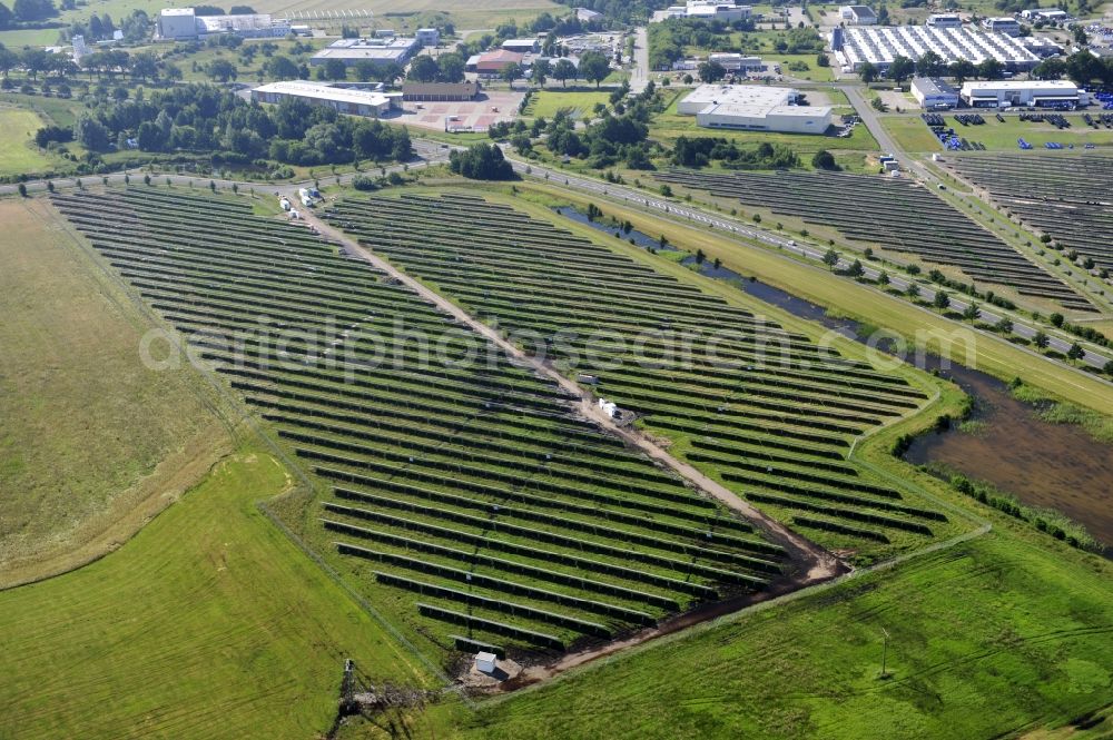 Boizenburg from the bird's eye view: Boizenburg 08/07/2012 Newly built solar panel, photovoltaic solar park or along the road 5 on the industrial and commercial area of the eastern edge of Boizenburg / Elbe. The plant operator is the EEPro Company