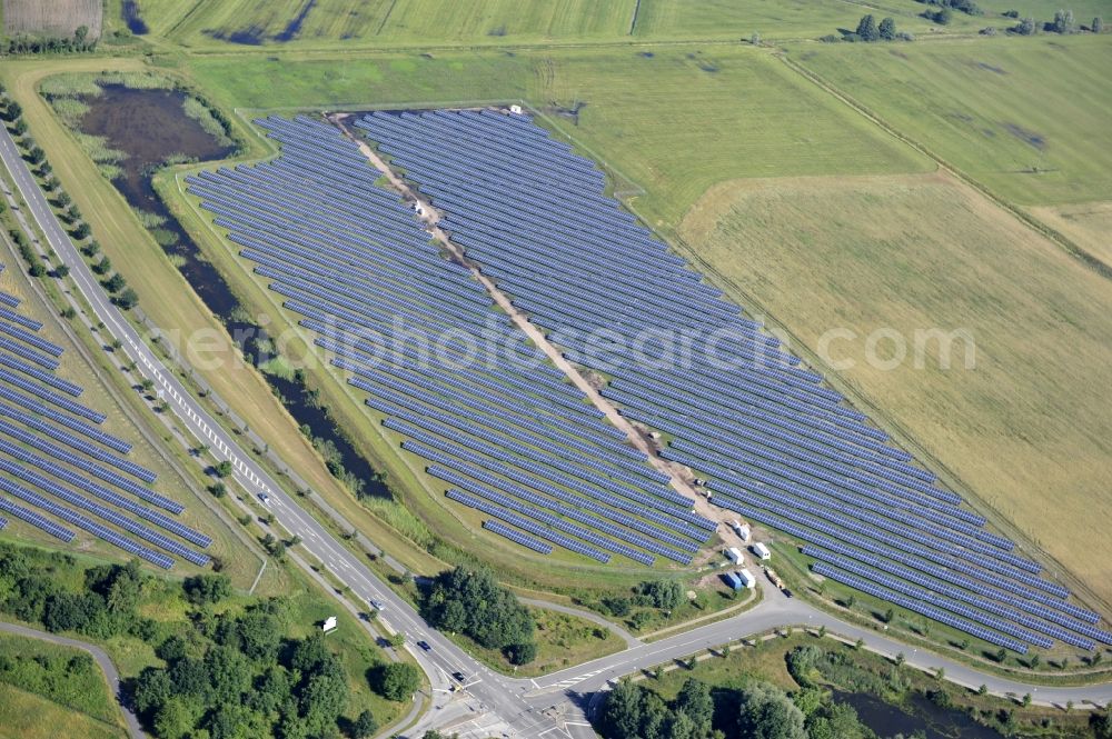 Boizenburg from above - Boizenburg 08/07/2012 Newly built solar panel, photovoltaic solar park or along the road 5 on the industrial and commercial area of the eastern edge of Boizenburg / Elbe. The plant operator is the EEPro Company