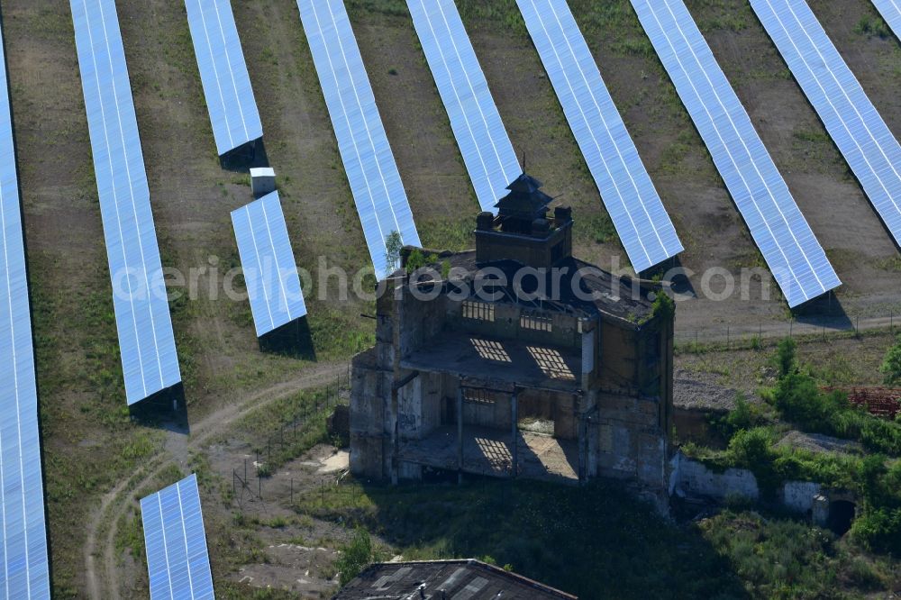 Muldenstein from the bird's eye view: Photovoltaic systems at the solar power plant on the facade ruins of the old pipe plant Muldenstein in the state of Saxony-Anhalt