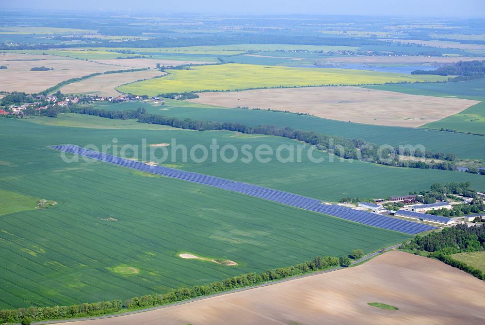 Dedelow from above - Solar power plant and photovoltaic systems on the former runway with the tarmac area of the airfield in Dedelow in the state Brandenburg, Germany