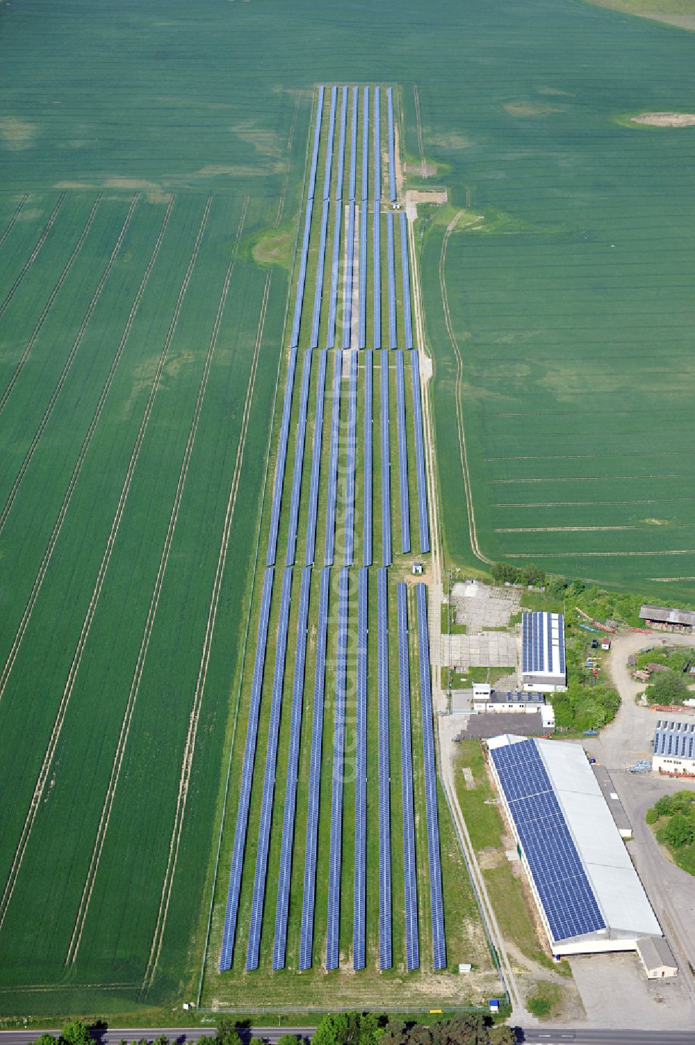 Dedelow from above - Solar power plant and photovoltaic systems on the former runway with the tarmac area of the airfield in Dedelow in the state Brandenburg, Germany