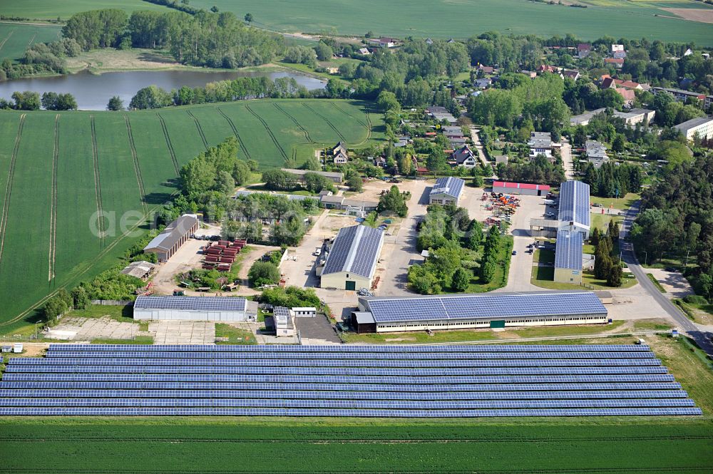 Dedelow from above - Solar power plant and photovoltaic systems on the former runway with the tarmac area of the airfield in Dedelow in the state Brandenburg, Germany