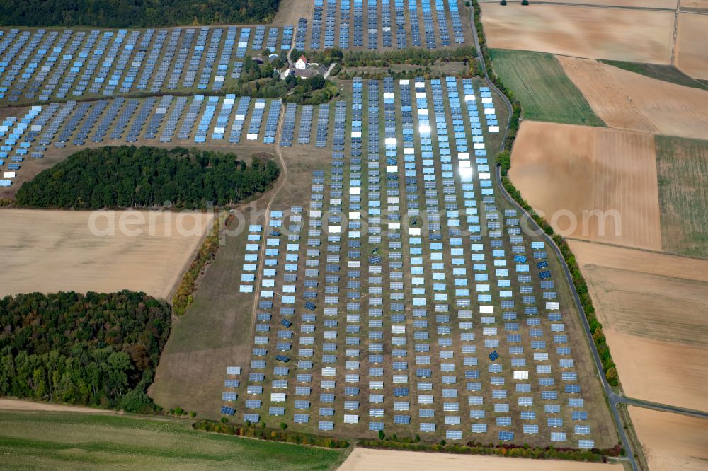 Erlasee from the bird's eye view: Rows of panels of a solar power plant and photovoltaic system on a field in Erlasee in the state Bavaria, Germany