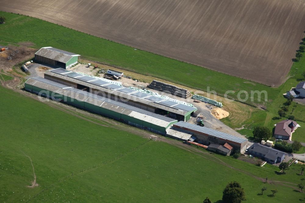 Varize from the bird's eye view: Solar power plant and photovoltaic systems on the roofs of a rural property in Varize in Grand Est, France