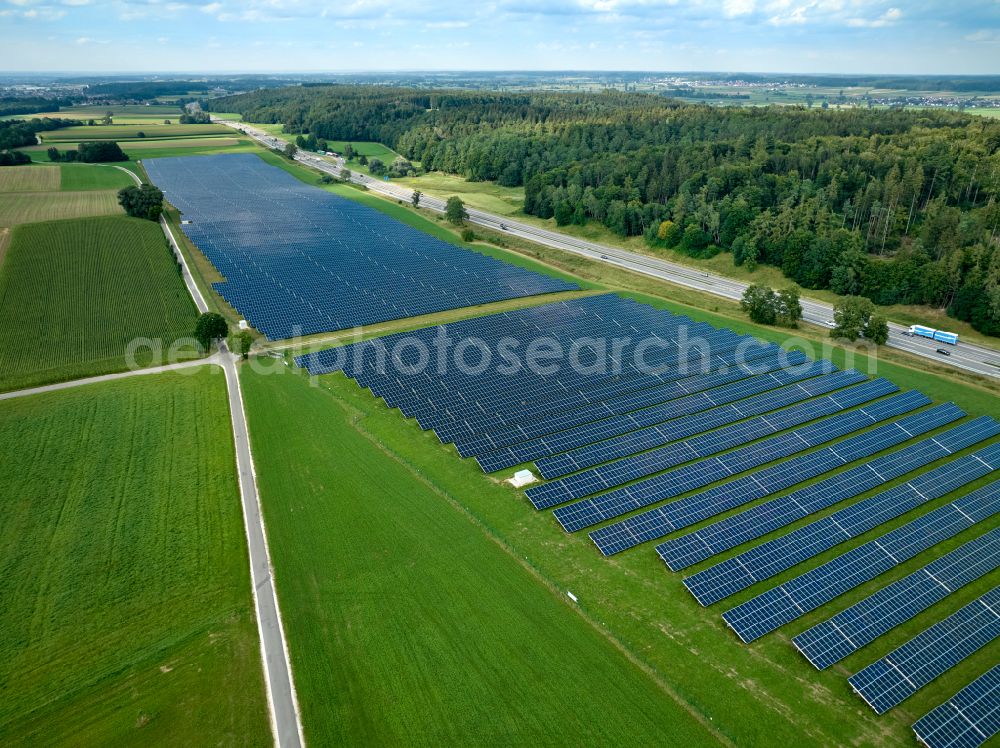 Altenstadt from the bird's eye view: Photovoltaic system and solar power plant - rows of panels on the edge of the lanes of the motorway route and route of the BAB A 81 in Altenstadt Unterallgaeu in the state Bavaria, Germany