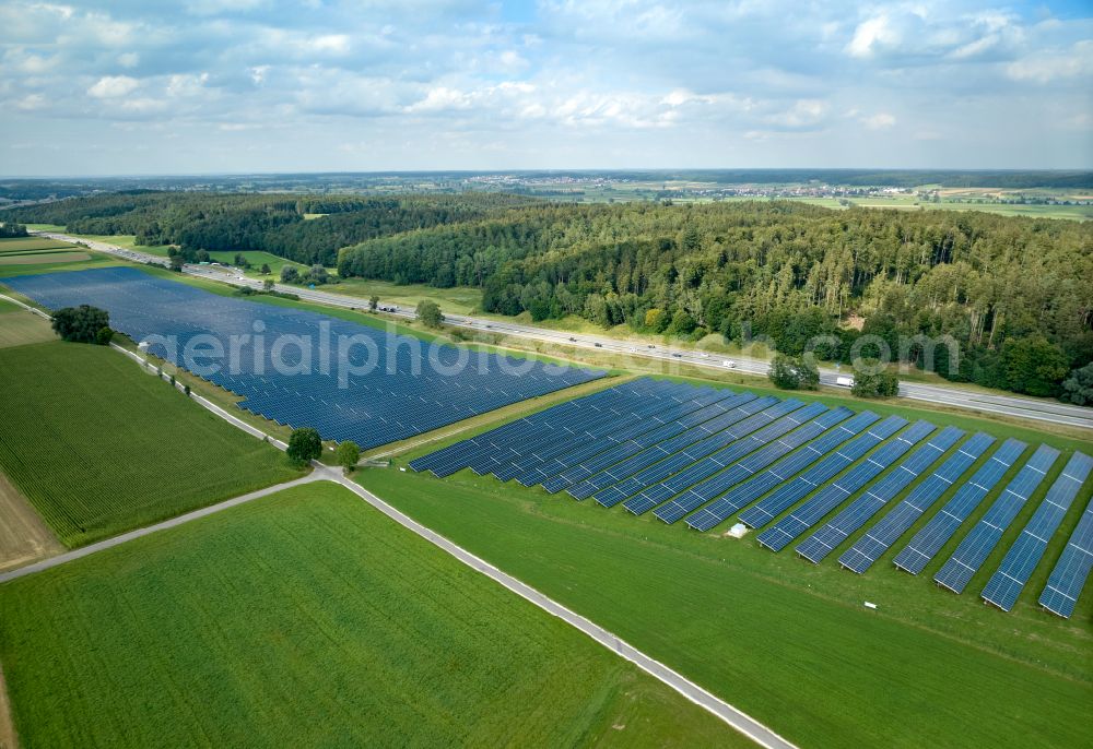 Altenstadt from the bird's eye view: Photovoltaic system and solar power plant - rows of panels on the edge of the lanes of the motorway route and route of the BAB A 81 in Altenstadt Unterallgaeu in the state Bavaria, Germany