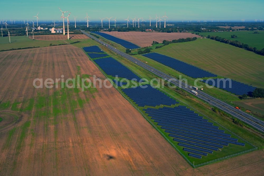 Aerial image Gerdshagen - Photovoltaic system and solar power plant - rows of panels on the edge of the lanes of the motorway route and route of the BAB A 24 in Gerdshagen in the state Brandenburg, Germany