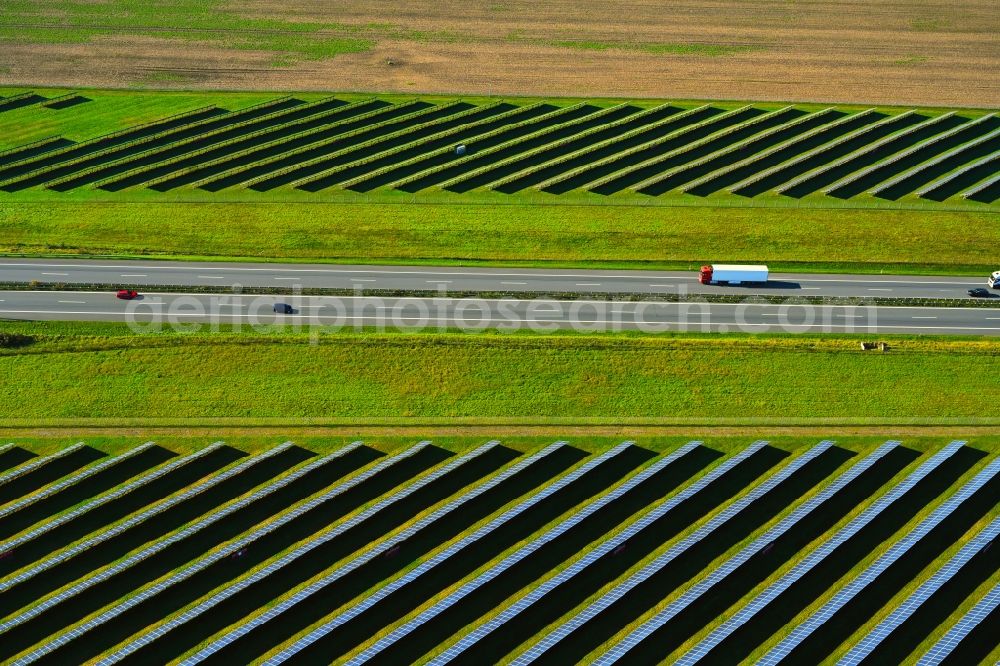 Aerial image Gerdshagen - Photovoltaic system and solar power plant - rows of panels on the edge of the lanes of the motorway route and route of the BAB A 24 in Gerdshagen in the state Brandenburg, Germany