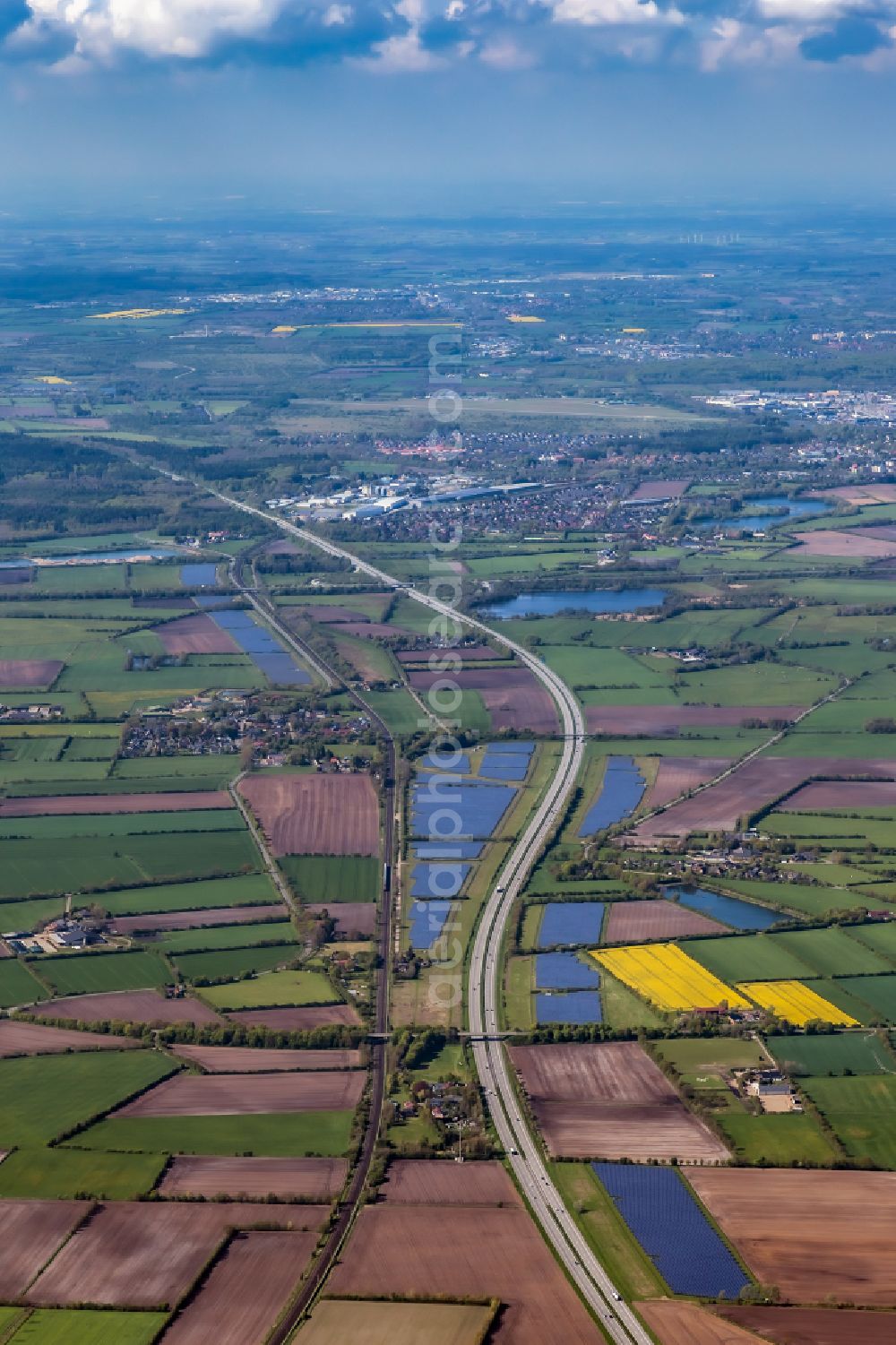 Aerial image Oeversee - Photovoltaic system and solar power plant - rows of panels on the edge of the lanes of the motorway route and route of the BAB A 7 in Oeversee in the state Schleswig-Holstein, Germany