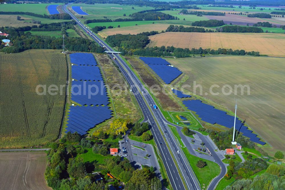 Aerial image Silmersdorf - Photovoltaic system and solar power plant - rows of panels on the edge of the lanes of the motorway route and route of the BAB A 24 in Silmersdorf in the state Brandenburg, Germany