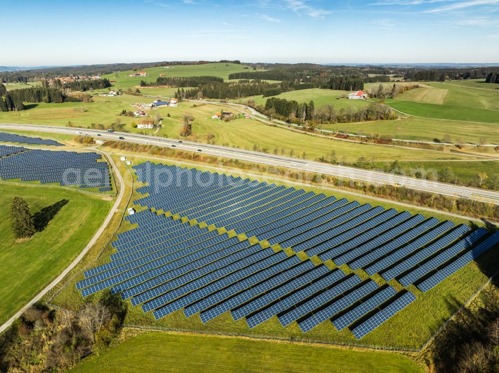 Sulzberg from above - Photovoltaic system and solar power plant - rows of panels at the edge of the lanes of the motorway route and route of the BAB A81 in Sulzberg Oberallgaeu in the federal state of Bavaria, Germany