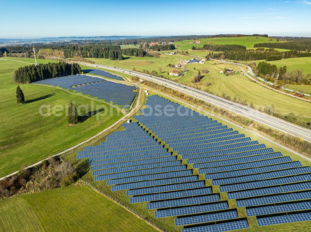 Sulzberg from the bird's eye view: Photovoltaic system and solar power plant - rows of panels at the edge of the lanes of the motorway route and route of the BAB A81 in Sulzberg Oberallgaeu in the federal state of Bavaria, Germany