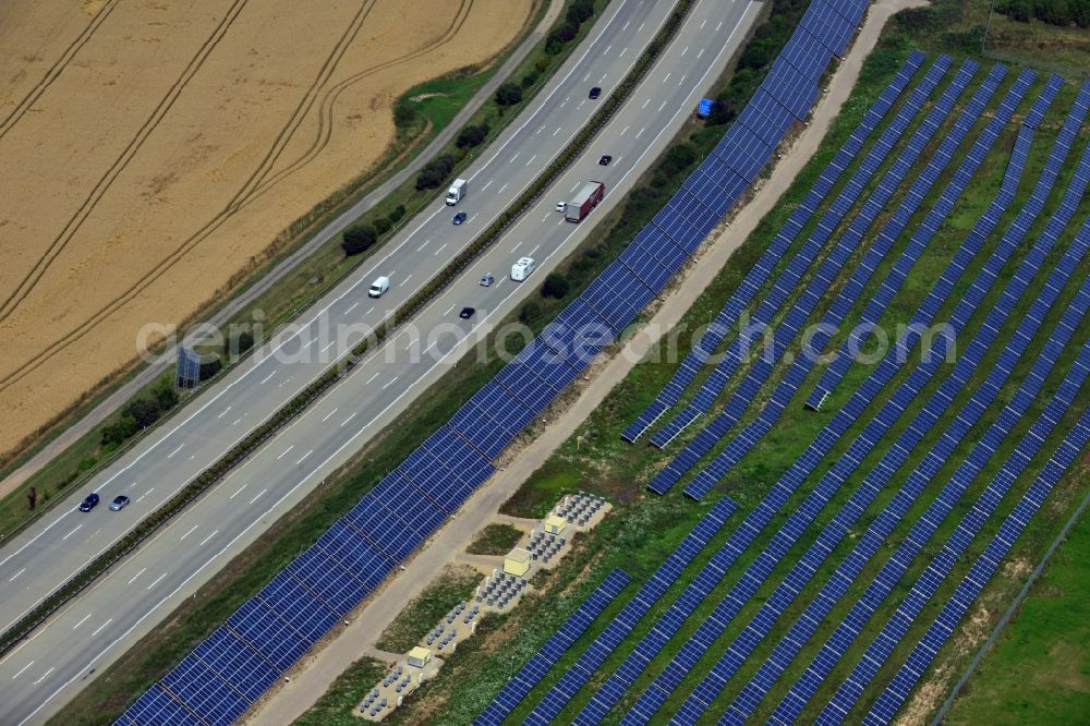 Rüdersdorf from the bird's eye view: Solar panels of the solar power plant along the motorway E4 motorway - A40 at Ruedersdorf in Thuringia