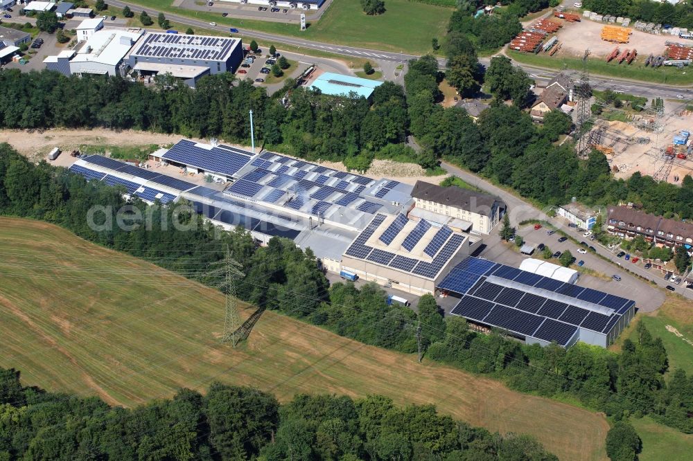 Wehr from above - Panel rows of photovoltaic and solar farm or solar power plant on the company's roof and roof areas of the Dreilaendereck GmbH in Wehr in the state Baden-Wuerttemberg