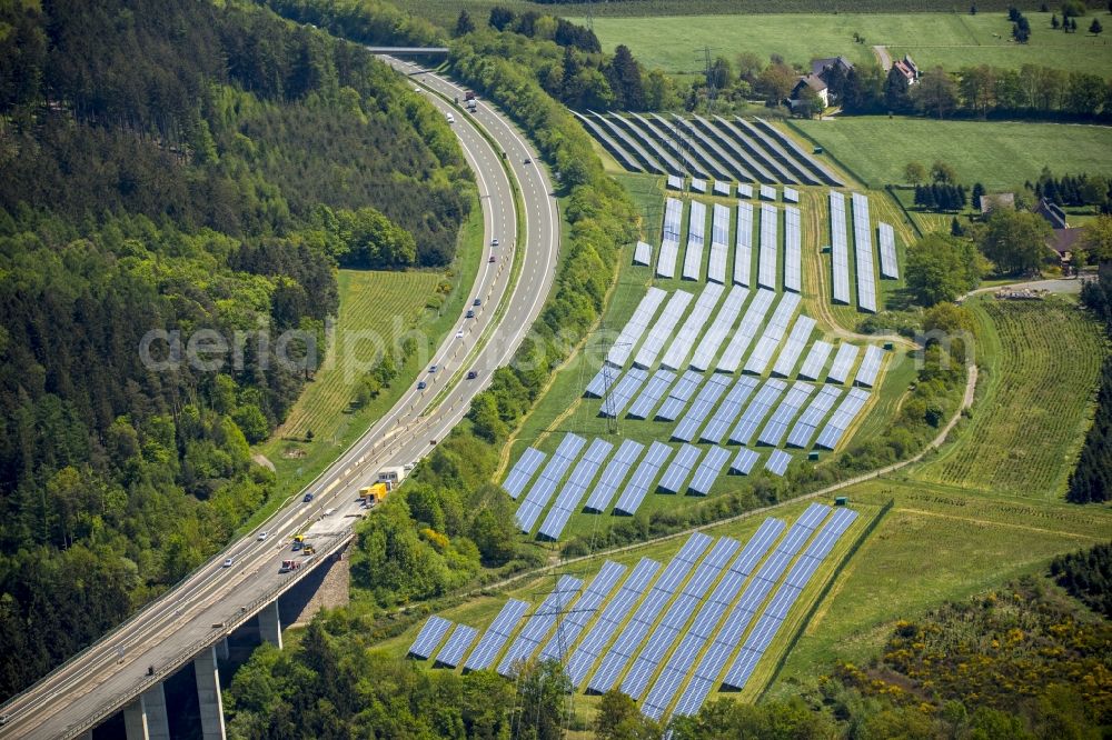 Meschede from above - Panel rows of photovoltaic and solar farm or solar power plant in Meschede in the state North Rhine-Westphalia