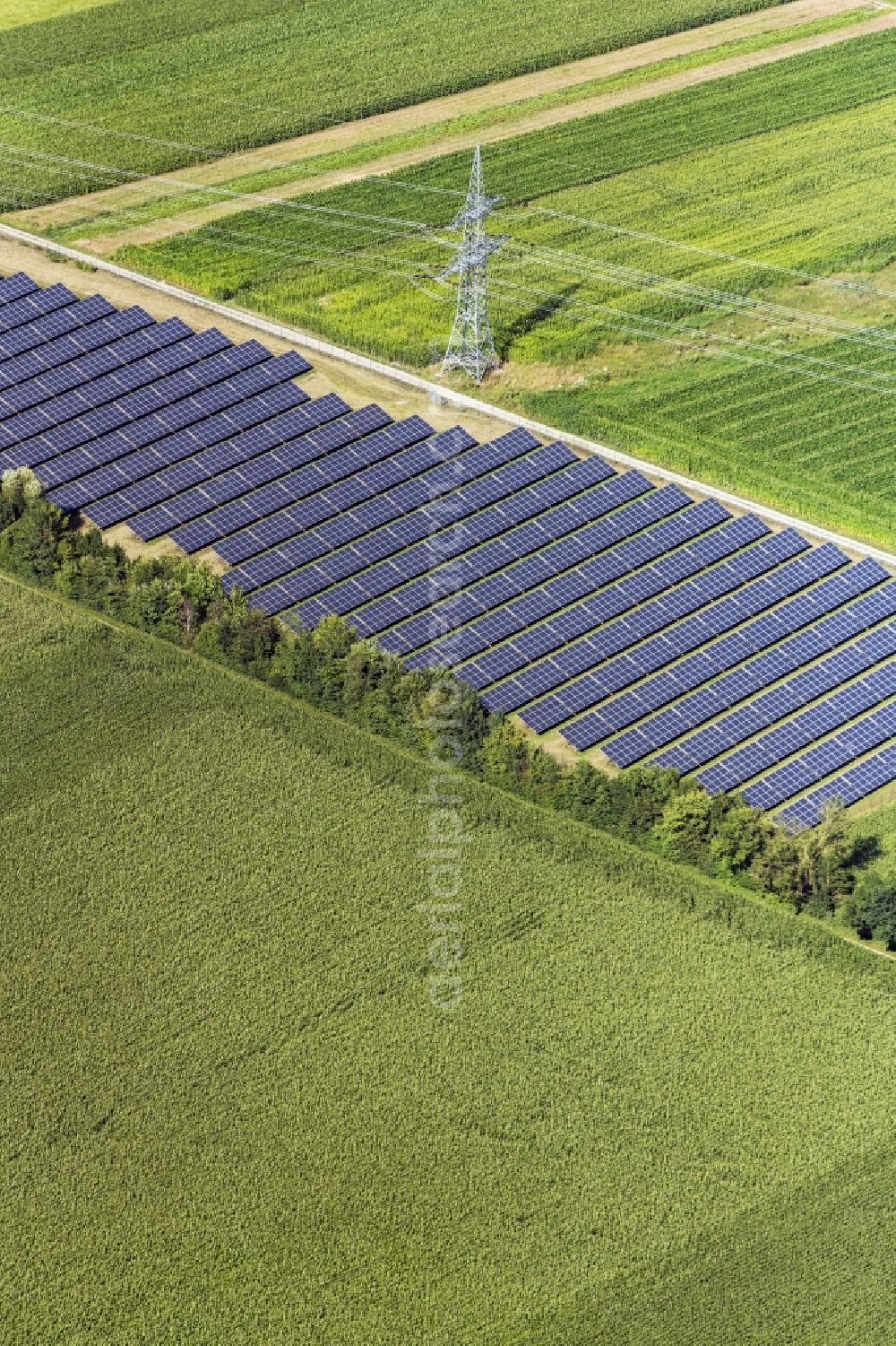 Neuching from above - Panel rows of photovoltaic and solar farm or solar power plant in Neuching in the state Bavaria, Germany