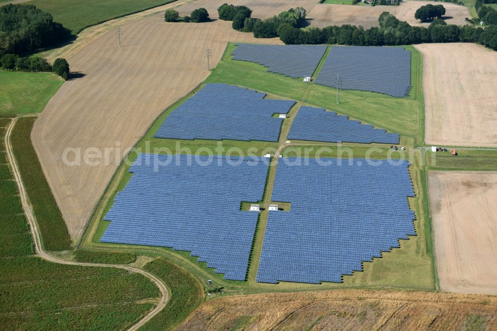 Otterwisch from the bird's eye view: Panel rows of photovoltaic and solar farm or solar power plant in Otterwisch in the state Saxony