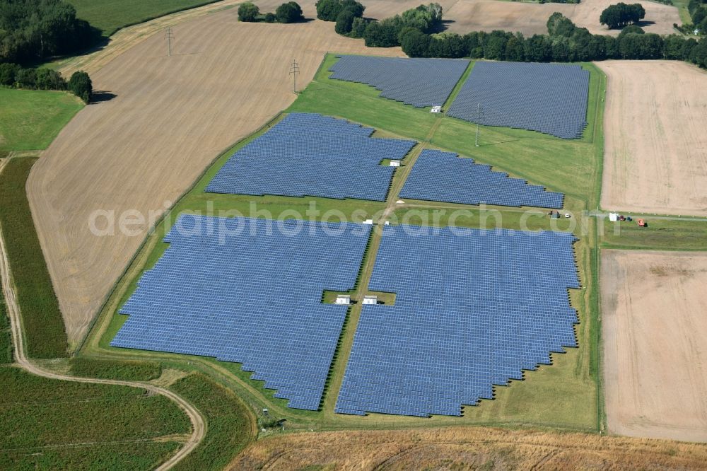 Aerial image Otterwisch - Panel rows of photovoltaic and solar farm or solar power plant in Otterwisch in the state Saxony