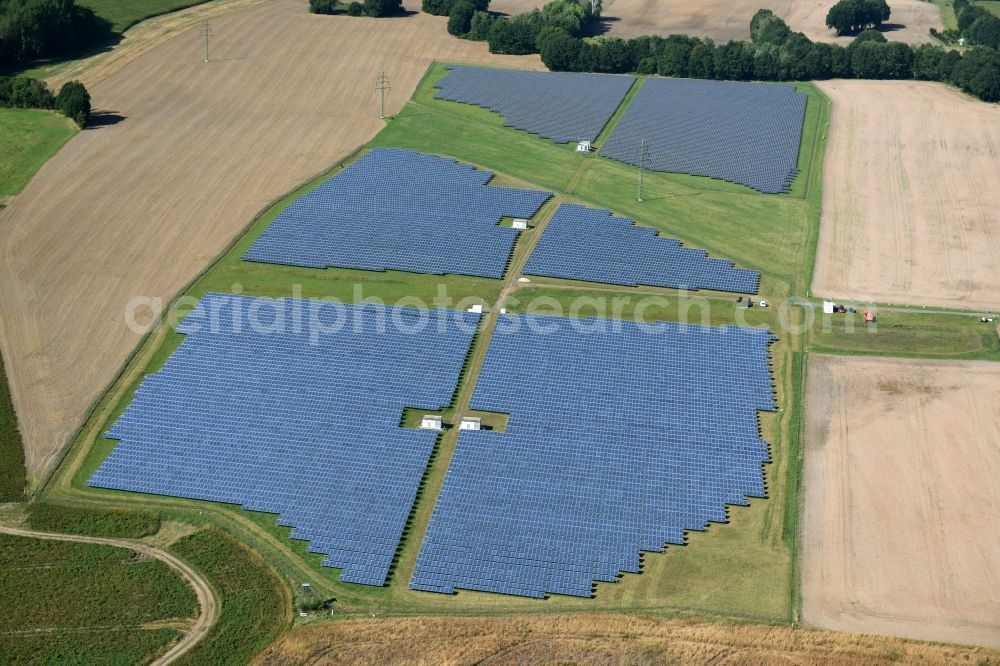 Aerial photograph Otterwisch - Panel rows of photovoltaic and solar farm or solar power plant in Otterwisch in the state Saxony