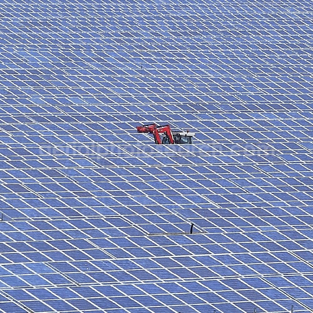 Aerial image Werneuchen - Panel rows of photovoltaic and solar farm or solar power plant in Werneuchen in the state Brandenburg