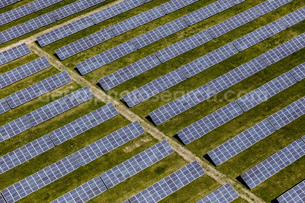 Werneuchen from above - Panel rows of photovoltaic and solar farm or solar power plant in Werneuchen in the state Brandenburg