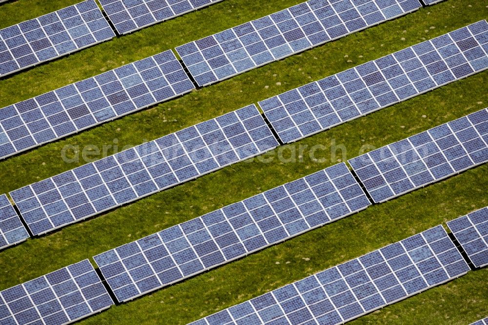 Werneuchen from the bird's eye view: Panel rows of photovoltaic and solar farm or solar power plant in Werneuchen in the state Brandenburg