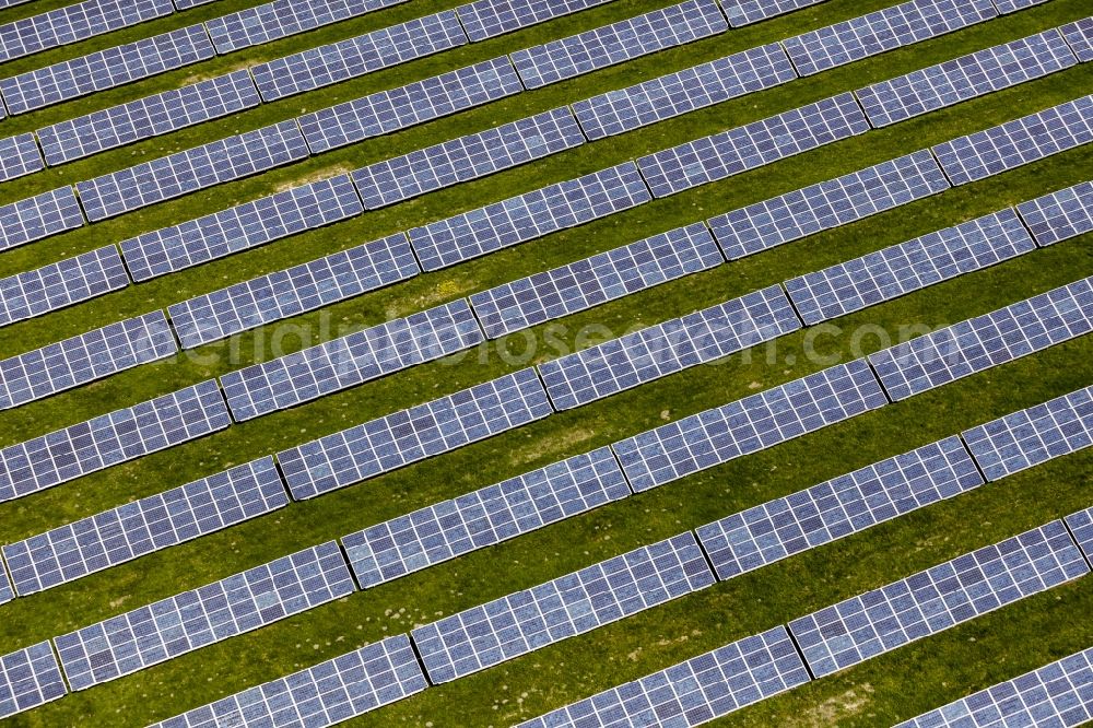 Aerial image Werneuchen - Panel rows of photovoltaic and solar farm or solar power plant in Werneuchen in the state Brandenburg