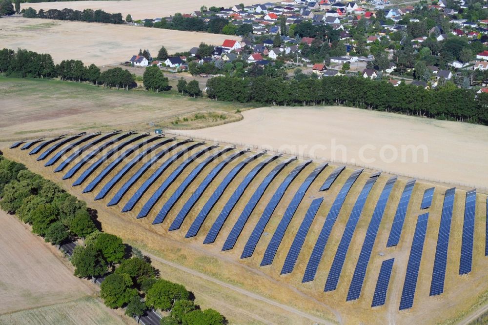 Werneuchen from above - Panel rows of photovoltaic and solar farm or solar power plant in Werneuchen in the state Brandenburg, Germany