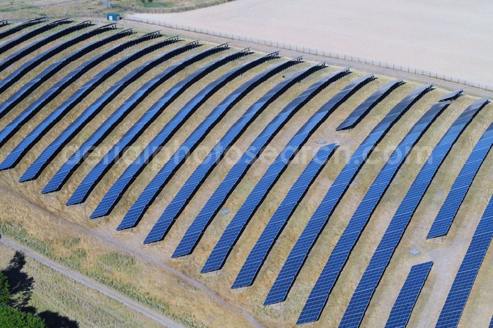 Werneuchen from the bird's eye view: Panel rows of photovoltaic and solar farm or solar power plant in Werneuchen in the state Brandenburg, Germany