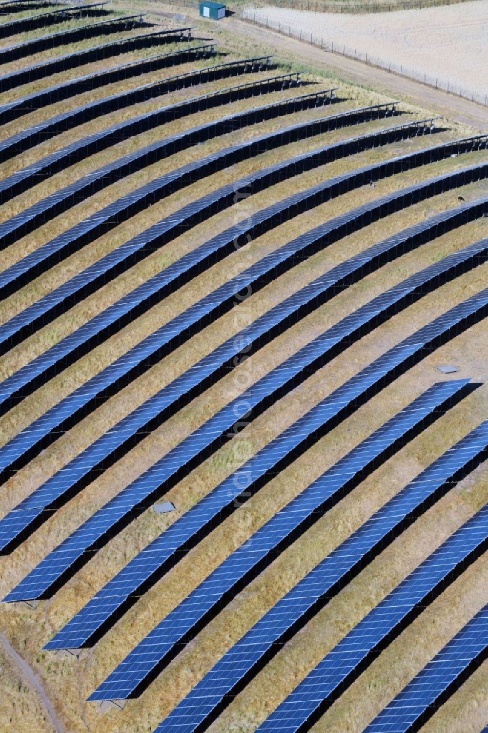 Aerial image Werneuchen - Panel rows of photovoltaic and solar farm or solar power plant in Werneuchen in the state Brandenburg, Germany