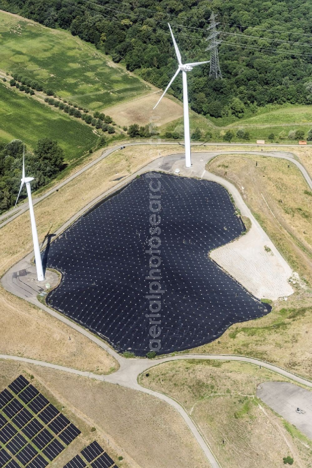 Karlsruhe from the bird's eye view: Panel rows of photovoltaic and solar farm or solar power plant and Windkraftraeder in Karlsruhe in the state Baden-Wuerttemberg, Germany