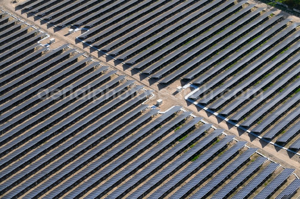 Zeithain from the bird's eye view: Panel rows of photovoltaic and solar farm or solar power plant in Zeithain in the state Saxony, Germany