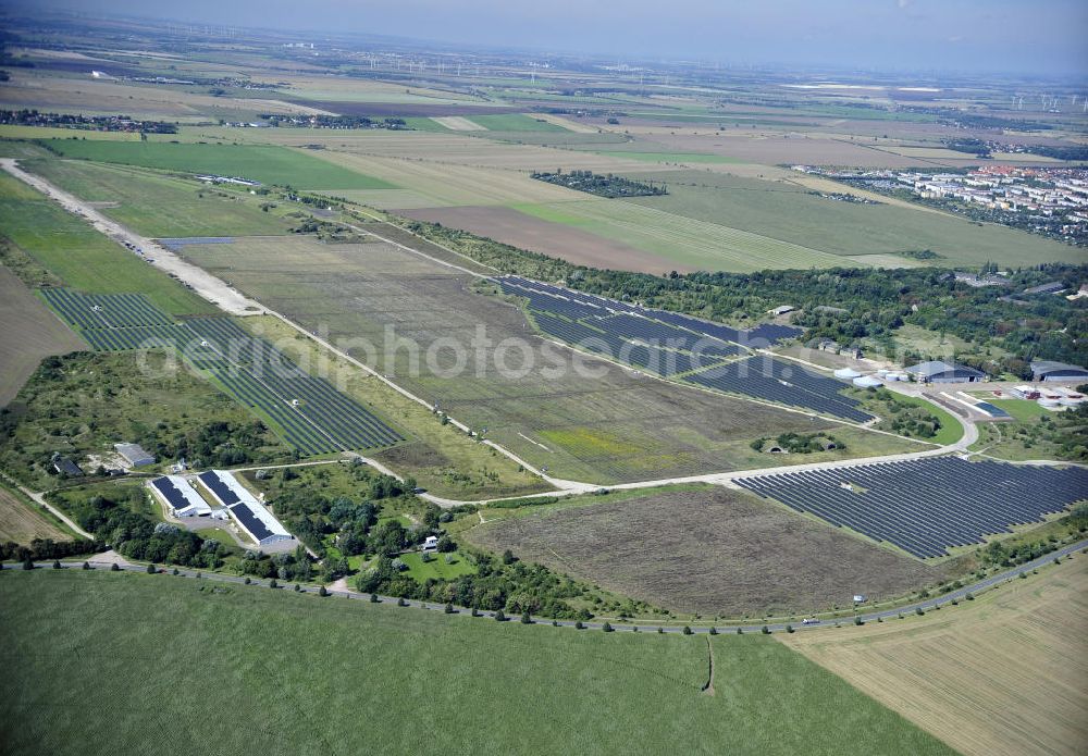 Köthen from the bird's eye view: Blick auf den Solarpark auf dem Flugplatz Köthen. Auf einer Fläche von 55 Hektar ist es das bundesweit zweitgrößte Photovoltaik-Kraftwerk und wurde 2008 in Betrieb genommen. Die hochmoderne PV-Anlage besteht aus ca. 200.000 dünnschicht Solarmodulen der Firma First Solar. Betrieben wird das Feld von der juwi solar GmbH. Solar Park at the former airfield Köthen.