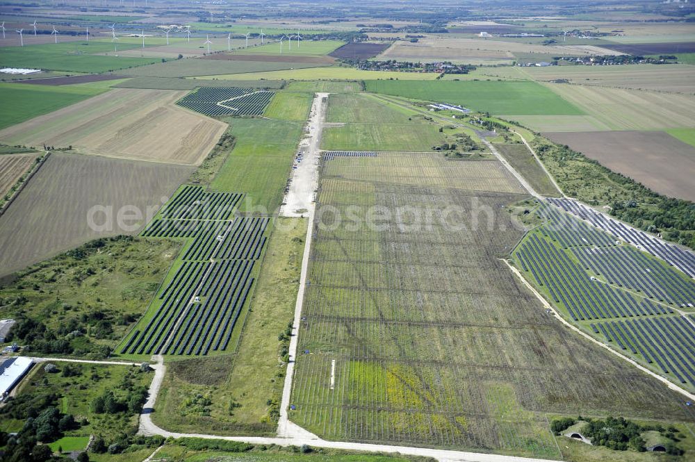 Aerial image Köthen - Blick auf den Solarpark auf dem Flugplatz Köthen. Auf einer Fläche von 55 Hektar ist es das bundesweit zweitgrößte Photovoltaik-Kraftwerk und wurde 2008 in Betrieb genommen. Die hochmoderne PV-Anlage besteht aus ca. 200.000 dünnschicht Solarmodulen der Firma First Solar. Betrieben wird das Feld von der juwi solar GmbH. Solar Park at the former airfield Köthen.