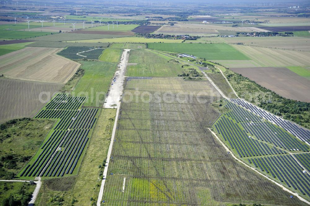 Aerial photograph Köthen - Blick auf den Solarpark auf dem Flugplatz Köthen. Auf einer Fläche von 55 Hektar ist es das bundesweit zweitgrößte Photovoltaik-Kraftwerk und wurde 2008 in Betrieb genommen. Die hochmoderne PV-Anlage besteht aus ca. 200.000 dünnschicht Solarmodulen der Firma First Solar. Betrieben wird das Feld von der juwi solar GmbH. Solar Park at the former airfield Köthen.