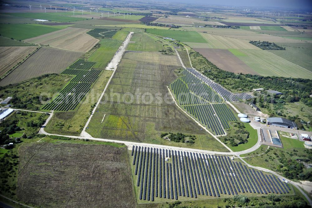 Köthen from above - Blick auf den Solarpark auf dem Flugplatz Köthen. Auf einer Fläche von 55 Hektar ist es das bundesweit zweitgrößte Photovoltaik-Kraftwerk und wurde 2008 in Betrieb genommen. Die hochmoderne PV-Anlage besteht aus ca. 200.000 dünnschicht Solarmodulen der Firma First Solar. Betrieben wird das Feld von der juwi solar GmbH. Solar Park at the former airfield Köthen.