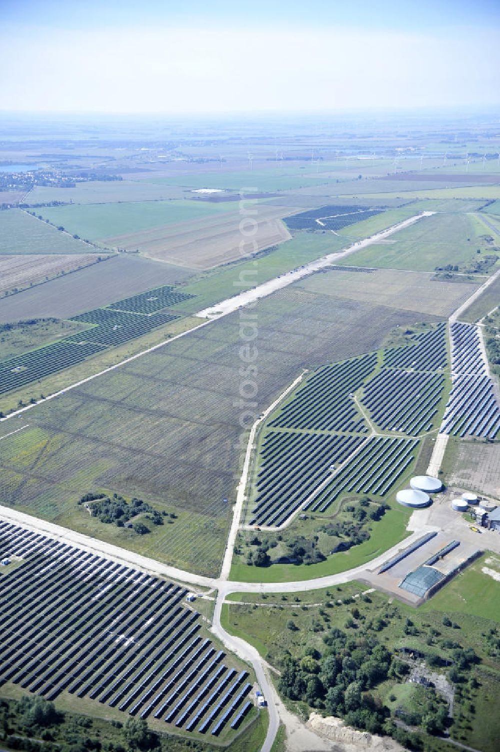 Köthen from the bird's eye view: Blick auf den Solarpark auf dem Flugplatz Köthen. Auf einer Fläche von 55 Hektar ist es das bundesweit zweitgrößte Photovoltaik-Kraftwerk und wurde 2008 in Betrieb genommen. Die hochmoderne PV-Anlage besteht aus ca. 200.000 dünnschicht Solarmodulen der Firma First Solar. Betrieben wird das Feld von der juwi solar GmbH. Solar Park at the former airfield Köthen.