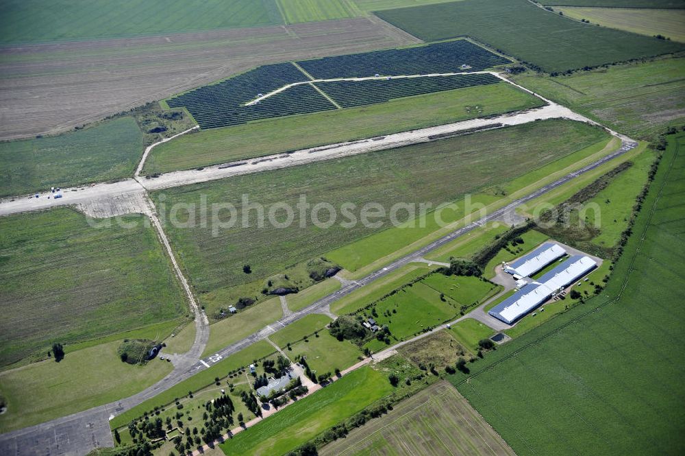 Aerial photograph Köthen - Blick auf den Solarpark auf dem Flugplatz Köthen. Auf einer Fläche von 55 Hektar ist es das bundesweit zweitgrößte Photovoltaik-Kraftwerk und wurde 2008 in Betrieb genommen. Die hochmoderne PV-Anlage besteht aus ca. 200.000 dünnschicht Solarmodulen der Firma First Solar. Betrieben wird das Feld von der juwi solar GmbH. Solar Park at the former airfield Köthen.