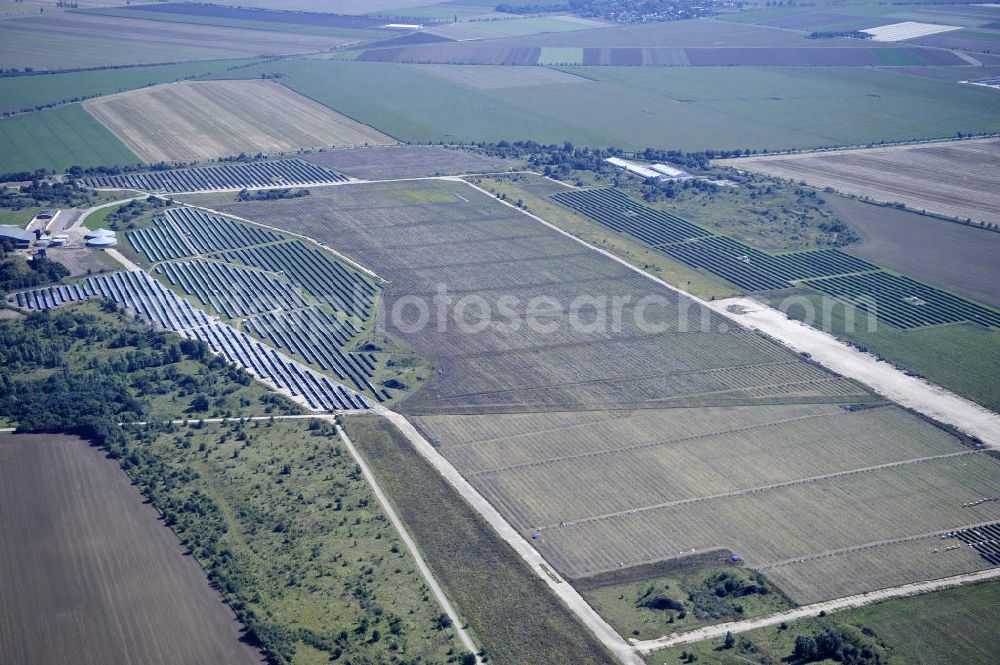 Köthen from above - Blick auf den Solarpark auf dem Flugplatz Köthen. Auf einer Fläche von 55 Hektar ist es das bundesweit zweitgrößte Photovoltaik-Kraftwerk und wurde 2008 in Betrieb genommen. Die hochmoderne PV-Anlage besteht aus ca. 200.000 dünnschicht Solarmodulen der Firma First Solar. Betrieben wird das Feld von der juwi solar GmbH. Solar Park at the former airfield Köthen.