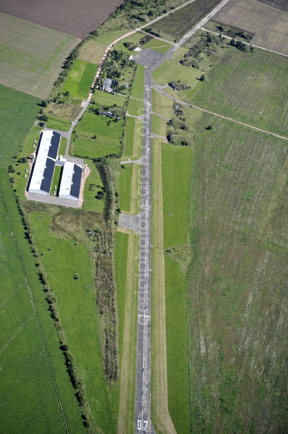 Köthen from the bird's eye view: Blick auf den Solarpark auf dem Flugplatz Köthen. Auf einer Fläche von 55 Hektar ist es das bundesweit zweitgrößte Photovoltaik-Kraftwerk und wurde 2008 in Betrieb genommen. Die hochmoderne PV-Anlage besteht aus ca. 200.000 dünnschicht Solarmodulen der Firma First Solar. Betrieben wird das Feld von der juwi solar GmbH. Solar Park at the former airfield Köthen.