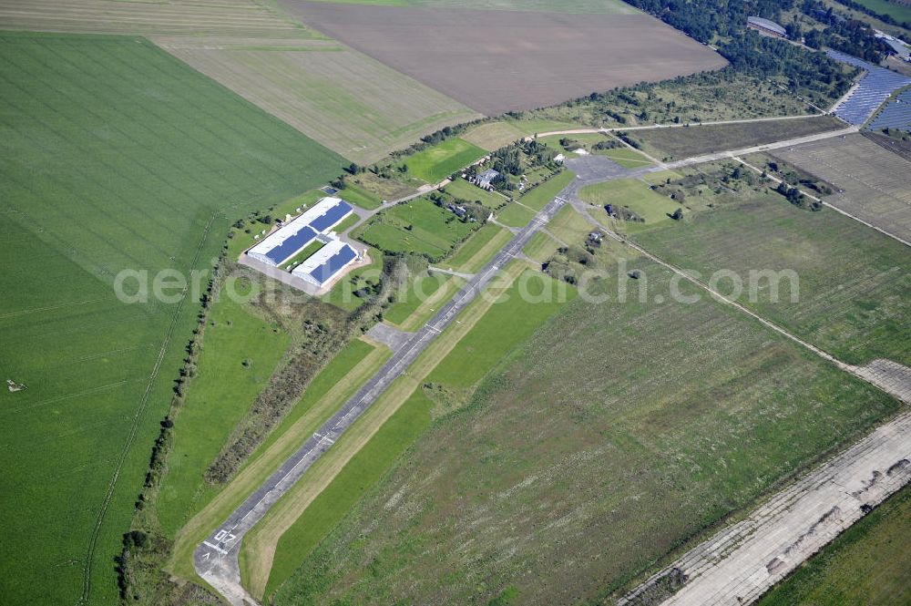 Aerial image Köthen - Blick auf den Solarpark auf dem Flugplatz Köthen. Auf einer Fläche von 55 Hektar ist es das bundesweit zweitgrößte Photovoltaik-Kraftwerk und wurde 2008 in Betrieb genommen. Die hochmoderne PV-Anlage besteht aus ca. 200.000 dünnschicht Solarmodulen der Firma First Solar. Betrieben wird das Feld von der juwi solar GmbH. Solar Park at the former airfield Köthen.