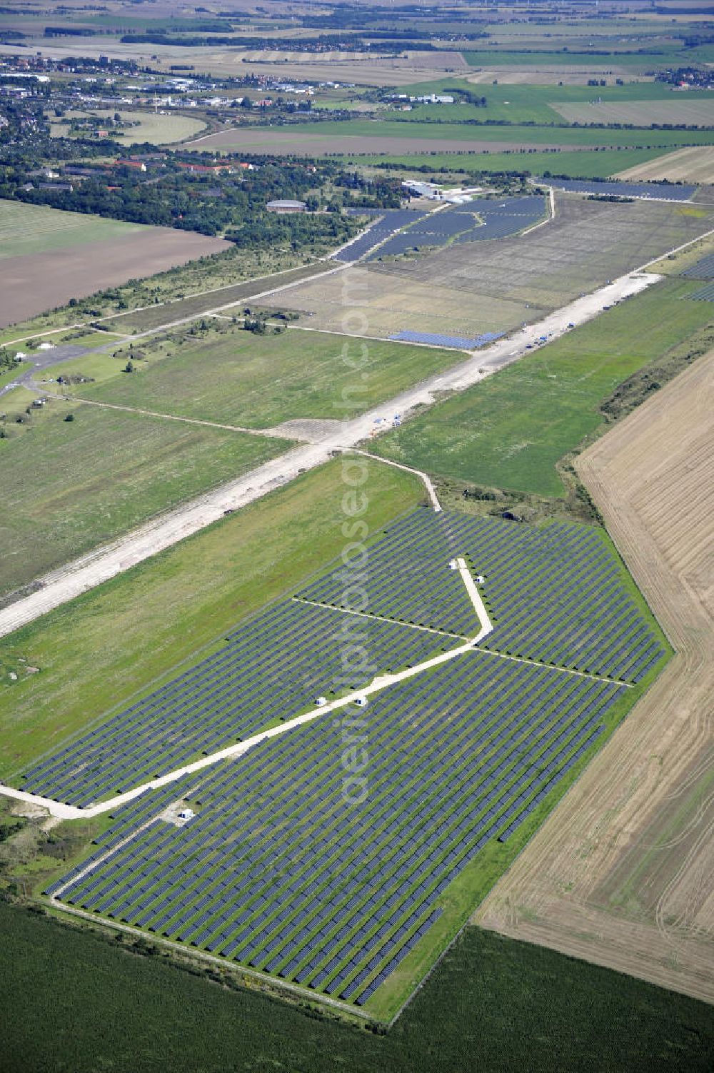 Köthen from the bird's eye view: Blick auf den Solarpark auf dem Flugplatz Köthen. Auf einer Fläche von 55 Hektar ist es das bundesweit zweitgrößte Photovoltaik-Kraftwerk und wurde 2008 in Betrieb genommen. Die hochmoderne PV-Anlage besteht aus ca. 200.000 dünnschicht Solarmodulen der Firma First Solar. Betrieben wird das Feld von der juwi solar GmbH. Solar Park at the former airfield Köthen.