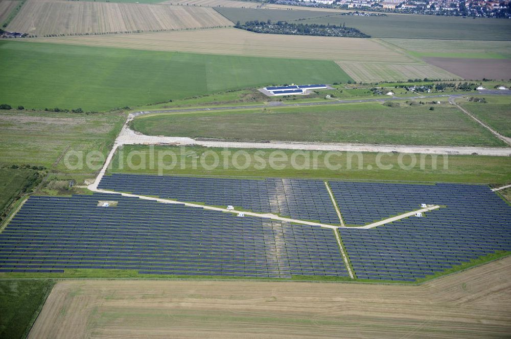 Aerial image Köthen - Blick auf den Solarpark auf dem Flugplatz Köthen. Auf einer Fläche von 55 Hektar ist es das bundesweit zweitgrößte Photovoltaik-Kraftwerk und wurde 2008 in Betrieb genommen. Die hochmoderne PV-Anlage besteht aus ca. 200.000 dünnschicht Solarmodulen der Firma First Solar. Betrieben wird das Feld von der juwi solar GmbH. Solar Park at the former airfield Köthen.