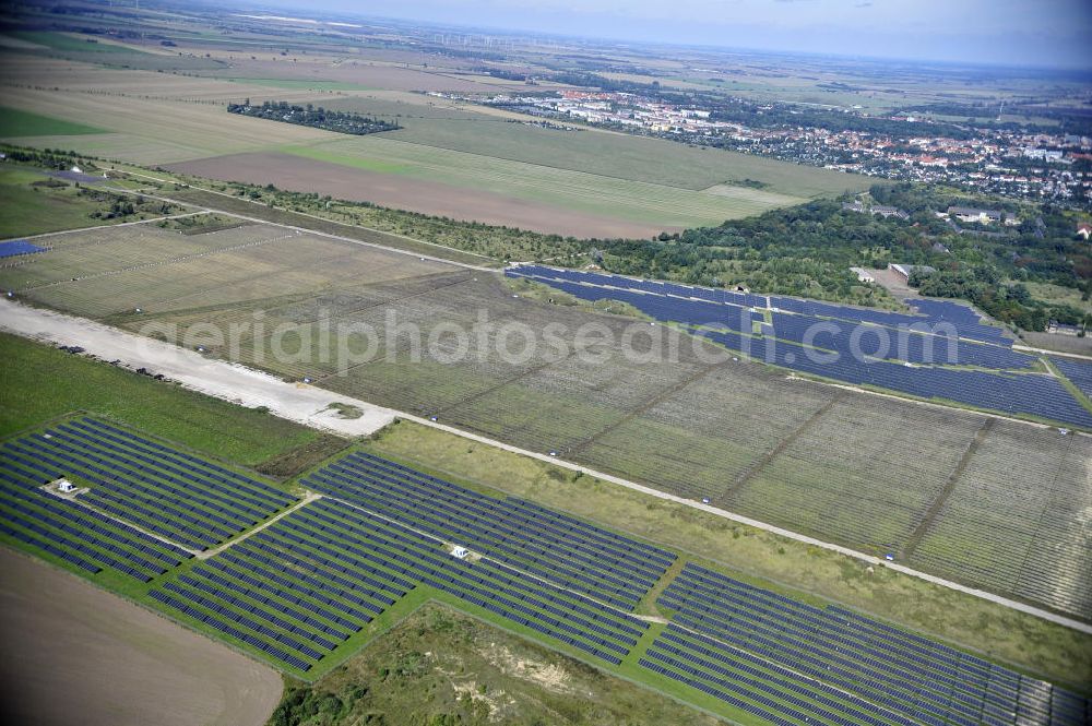 Köthen from the bird's eye view: Blick auf den Solarpark auf dem Flugplatz Köthen. Auf einer Fläche von 55 Hektar ist es das bundesweit zweitgrößte Photovoltaik-Kraftwerk und wurde 2008 in Betrieb genommen. Die hochmoderne PV-Anlage besteht aus ca. 200.000 dünnschicht Solarmodulen der Firma First Solar. Betrieben wird das Feld von der juwi solar GmbH. Solar Park at the former airfield Köthen.