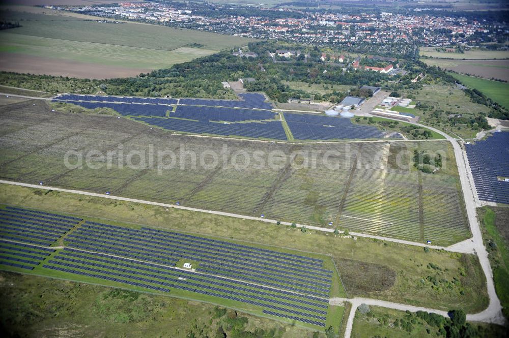 Aerial image Köthen - Blick auf den Solarpark auf dem Flugplatz Köthen. Auf einer Fläche von 55 Hektar ist es das bundesweit zweitgrößte Photovoltaik-Kraftwerk und wurde 2008 in Betrieb genommen. Die hochmoderne PV-Anlage besteht aus ca. 200.000 dünnschicht Solarmodulen der Firma First Solar. Betrieben wird das Feld von der juwi solar GmbH. Solar Park at the former airfield Köthen.