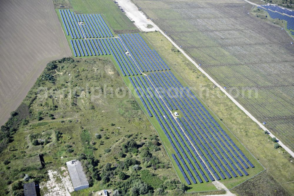 Aerial photograph Köthen - Blick auf den Solarpark auf dem Flugplatz Köthen. Auf einer Fläche von 55 Hektar ist es das bundesweit zweitgrößte Photovoltaik-Kraftwerk und wurde 2008 in Betrieb genommen. Die hochmoderne PV-Anlage besteht aus ca. 200.000 dünnschicht Solarmodulen der Firma First Solar. Betrieben wird das Feld von der juwi solar GmbH. Solar Park at the former airfield Köthen.